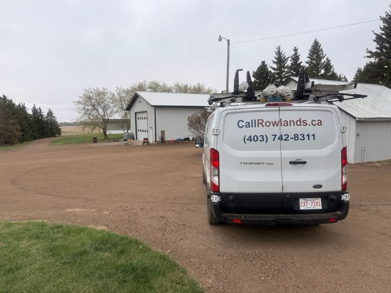 Rowland's Plumbing van on a Central Alberta acreage